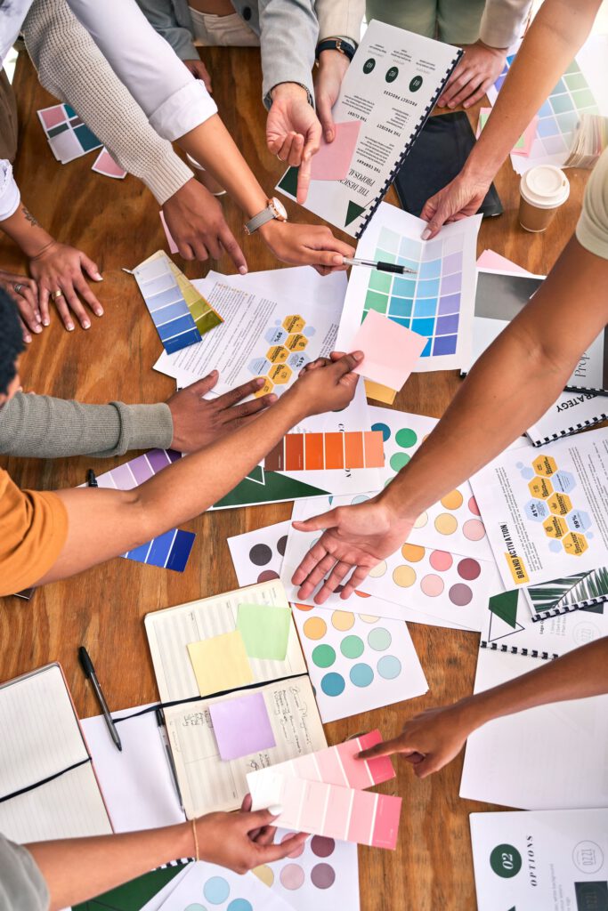 Color, design palette and hands of business people on desk for branding meeting, strategy and marke